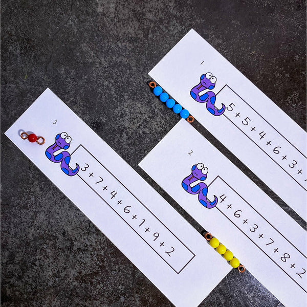 Cute cartoon snakes and long linear addition questions on three JRMontessori task cards