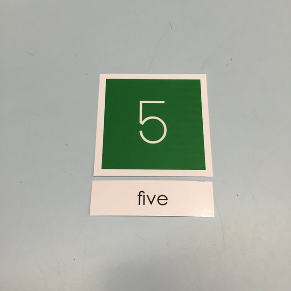 White 5 on a green background with the word "five" on a separate label. Example of a JRMontessori matching reading card.